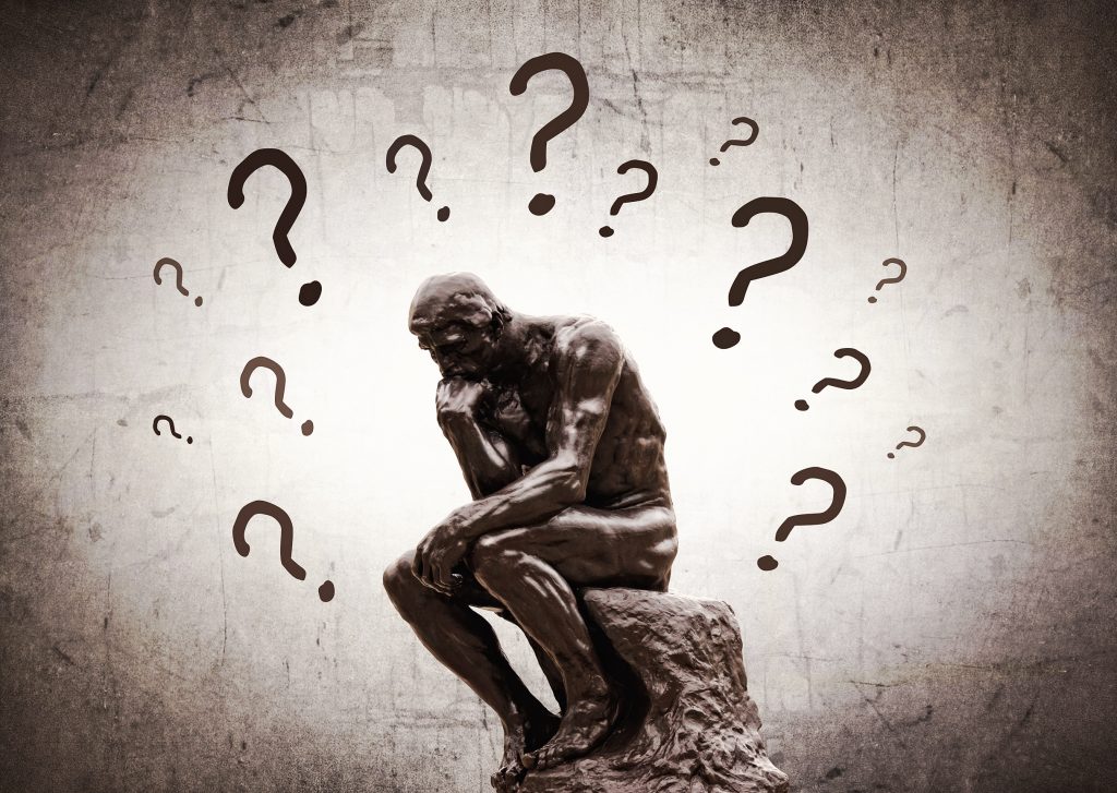 Rodins Thinker surrounded by question marks - Doubts and insecurities concept